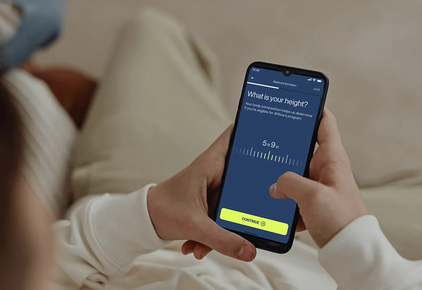 Person holding medication and phone during free assessment