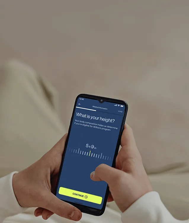 Person holding medication and phone during free assessment